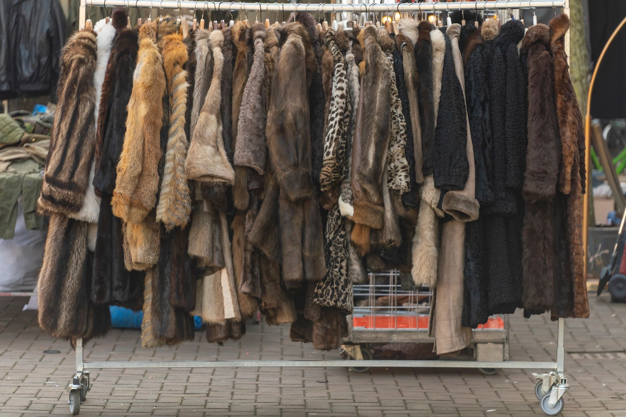 Vintage coats displayed on a clothing rack in a boutique setting
